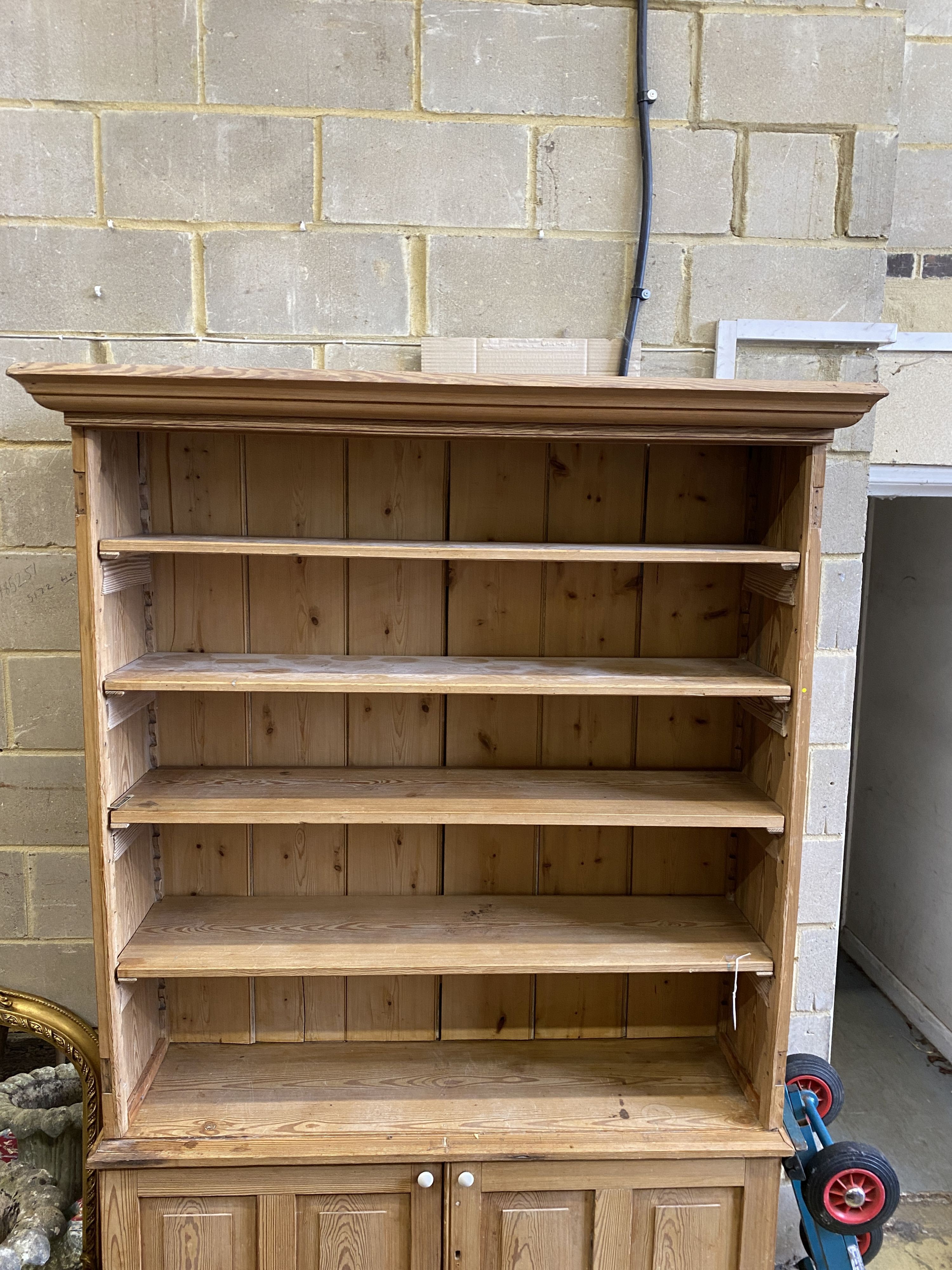 A Victorian stripped pine open fronted bookcase cupboard, length 150cm, depth 42cm, height 214cm